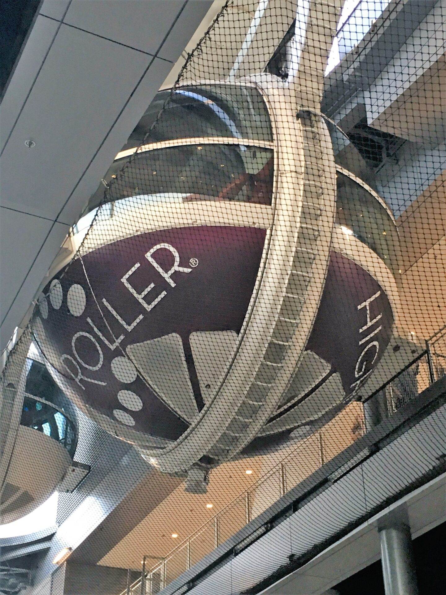 A large ball hanging from the ceiling of a building.